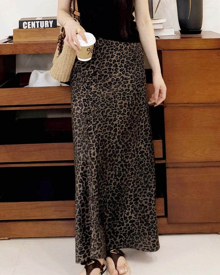 Person wearing a leopard print skirt in an indoor setting.